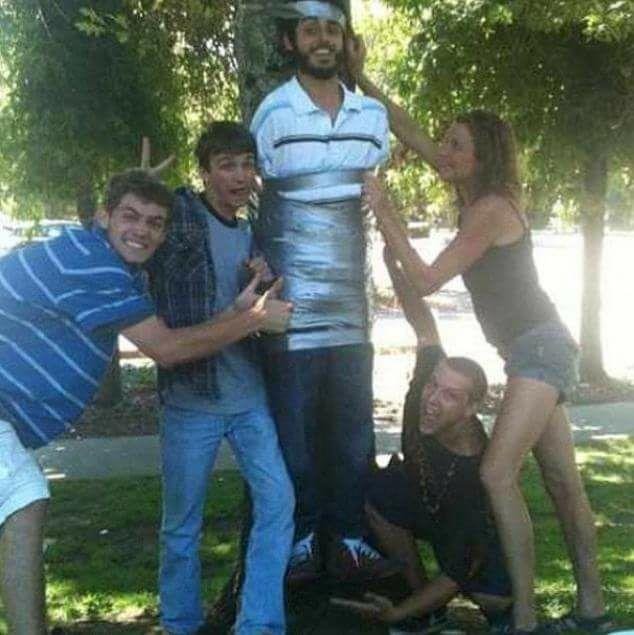 My son Jimmy Butcher, Chase, Christine Bielefield, Ben Romaine duck taping their friend Kumar Thedirk to the tree at Marinwood Park.