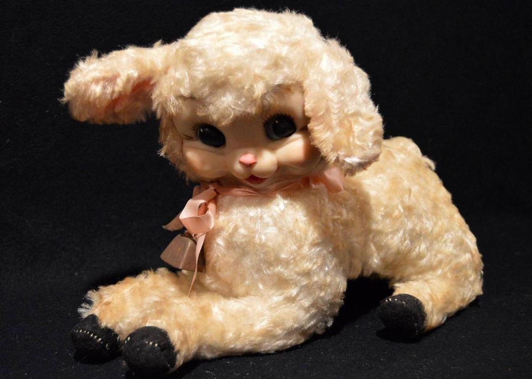 Please help me find my precious childhood friend. Below is a picture true of a much smaller version. I believe he is by Ruston. Lammie is about 28 to 30 inches long and 12 inches high. He has blue eyes a pink mouth, and