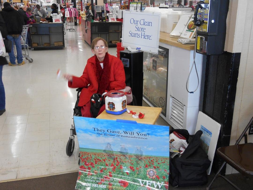 VFW Post 7356 Ladies Auxiliary member Bobbie Jordan distributes Buddy Poppies at Red X during Veterans Day weekend.