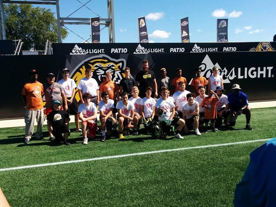 Hamilton Tigercat player takes pic with both Hamilton and Flint flag football players Kathy Mack Hunt