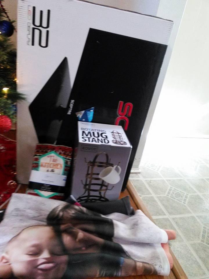 Merry Christmas to ME  Blanket with pics of my grandkids and coffee cup tower from Vicky Marie. And kitchen towel AND a new bigger TV from my son and his girl. Cory Walck and Jessica Dark