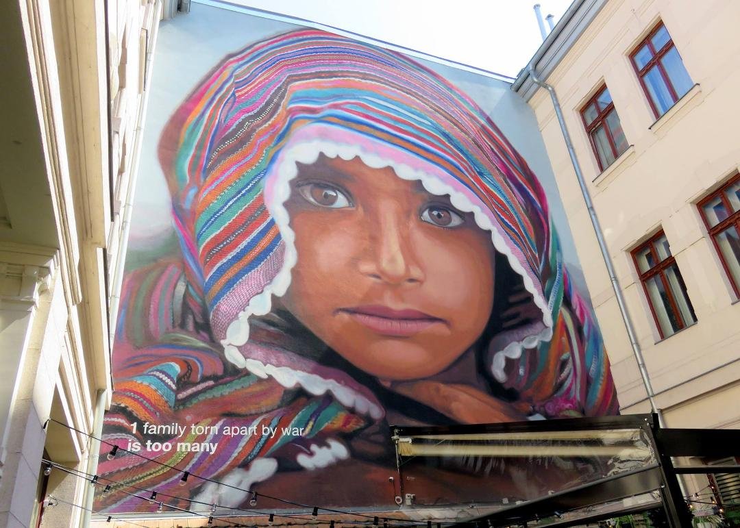 "One family torn apart by war is too many" Mural in a courtyard in Budapest.