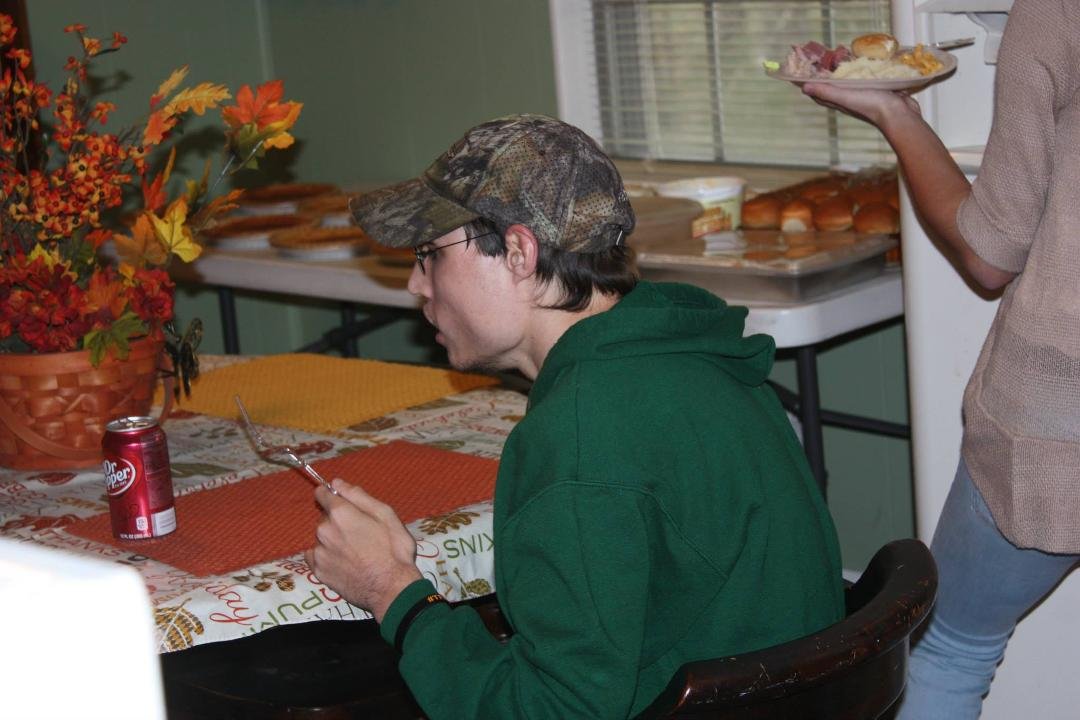 Coty with fork in hand waiting for his dinner