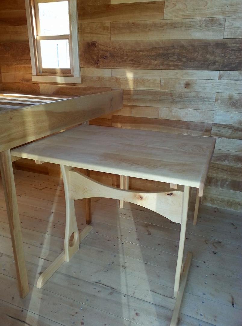 Table slides out from under the bed. Just need to finish curtain and mattress