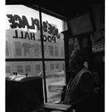 Building Demolition/ Barber shop, Pool Hall, South Omaha
A man in a sweater is looking out of the window of a pool hall. The text on the window reads "JOE'S PLACE", "POOL HALL", and "HOT DOGS - POLISH".
1969-02