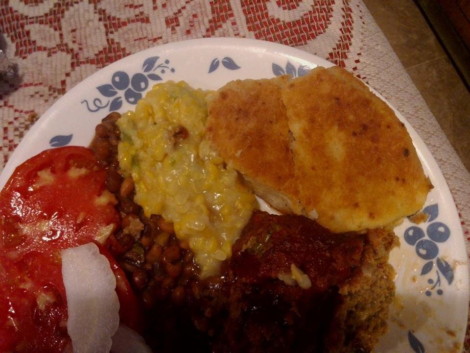 Homemade bisq,fried corn fresh purple hull peas,meatloaf,sliced tomato,onion,southern comfort