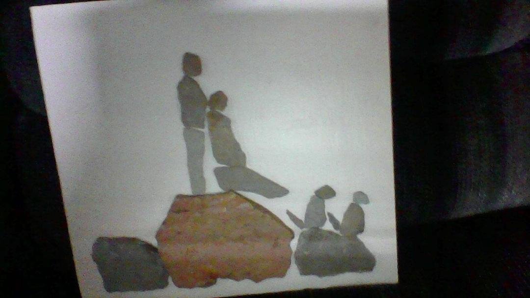 Not a good picture but this is one of the awesome presents I got for mother's day.   My daughter took a piece of plywood painted it white then hand picked stones/rocks and created this awesome piece of art...It is of Romeo 