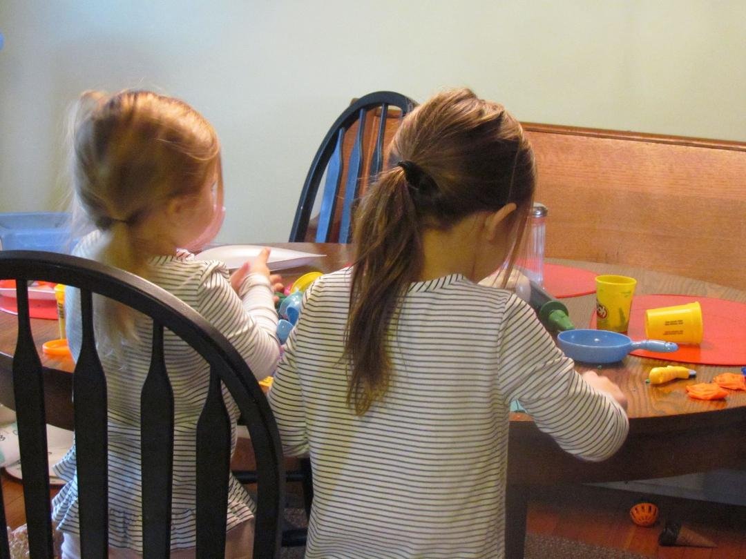 The girls enjoy playing with Play Doh.