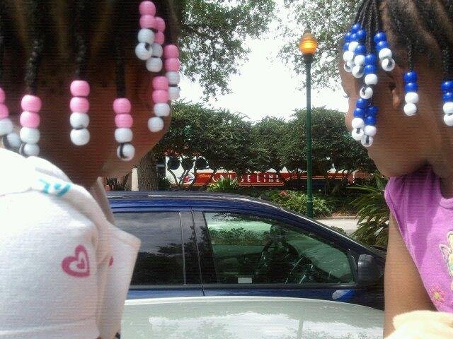 Girls looking at Disney Bus behind them.