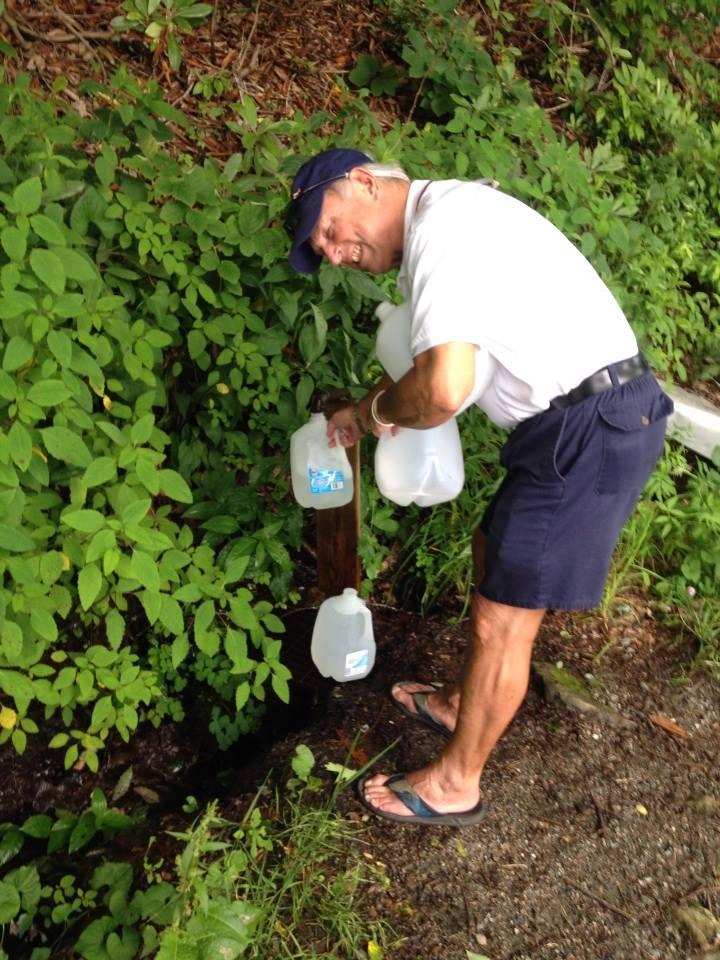 Leslie gathering our fresh spring water from the side of the mountain!