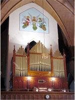 1895 2/21 Tracker action Midmer organ case. Great & Pedal in case. Swell box just behind arch (black arch visible in bell tower below mural). Console pictured 2002 3/56 Rodgers 950B.