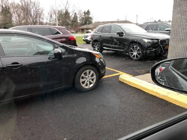 Two cars at the Clay Eye Center that really need to have their eyes examined.