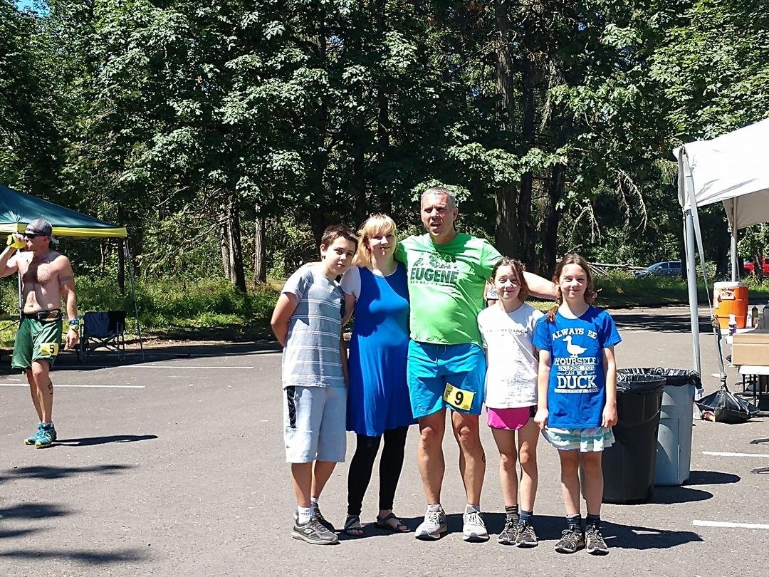 My niece's husband  Jared Hass with their family after mile 15 of a 24 hour run at Elijah Bristow Park in Dexter, Oregon.  He's aiming for 100 miles!!