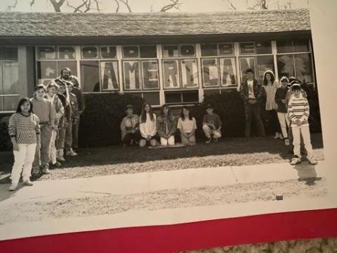 My class did this days after we invaded Kuwait to drive Iraq out. The American letters are almost 3 feet tall. You cannot see it in this black and white, but each letter starts with a bit blue letter glued to the white so t