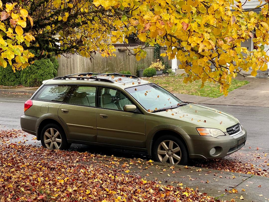 Kirk’s old 2006 Subaru Outback, a legacy from his Grandma Della Hunter, sits (inoperable) in front of the house.