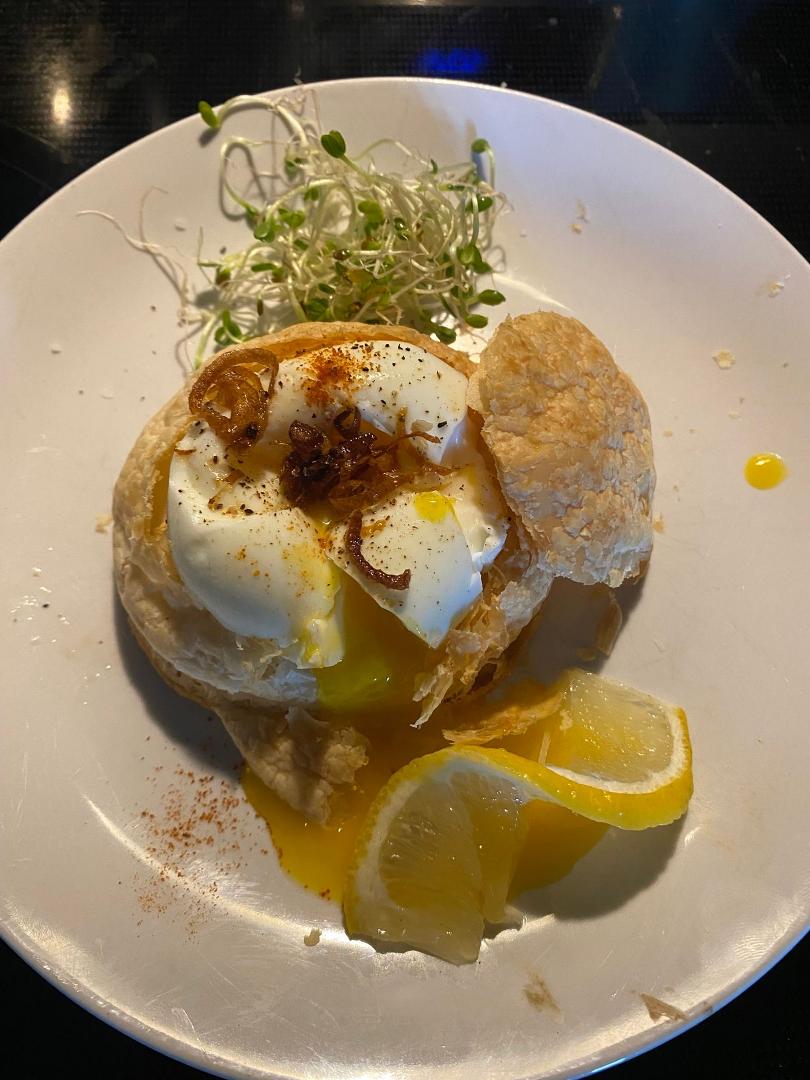 Soft boiled egg on puff pastry with micro greens