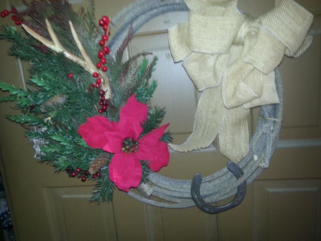 New wreath from 1 craft fair I visited today! It's an authentic lasso w/burlap bow & real horseshoe. Picture doesn't do it justice-hung it on my front door!! <3 <3