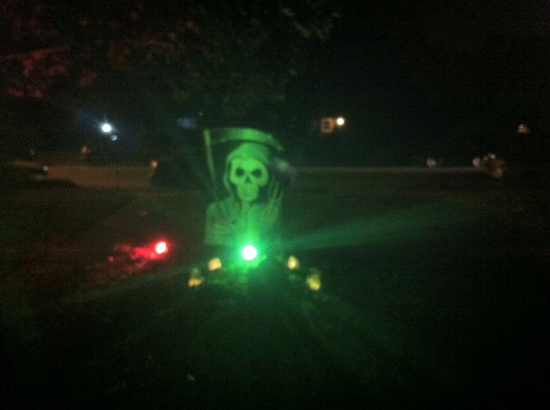 the grim reaper rises from his grave on our front lawn