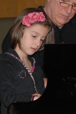 Sophia at her first piano recital, with organizer.