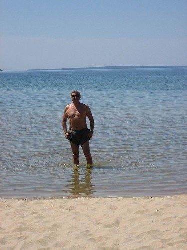 Me snapped while sampling frigid Lake Superior South of Wawa in early June 2006 on the inmotionforthemissing cycling trip across Canada.