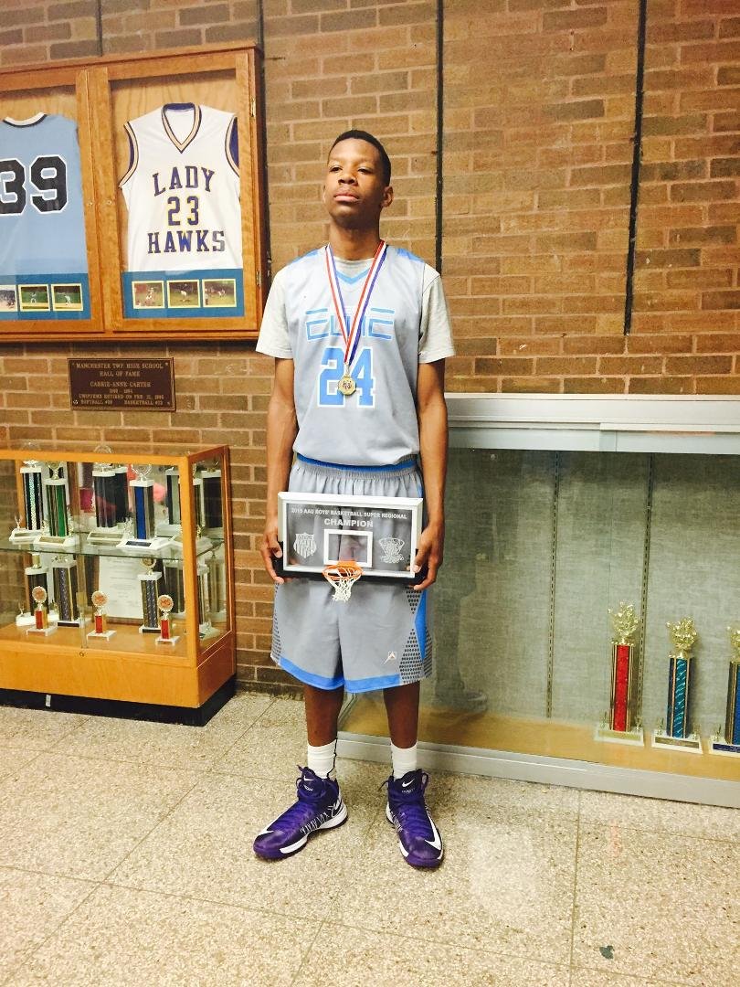 My nephew LJ holding the team trophy. Looks a little tired, but played three games today. They won an AAU Tournament today! Congrats!