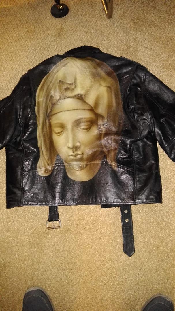 My Good Friday leather wishes everyone a Holy Day of Reflection, Prayer and Peace. Just noticed an image to the right of Mary's neck. Appears to be a person with a band on it's head, figuratively thorns? An apparition? I