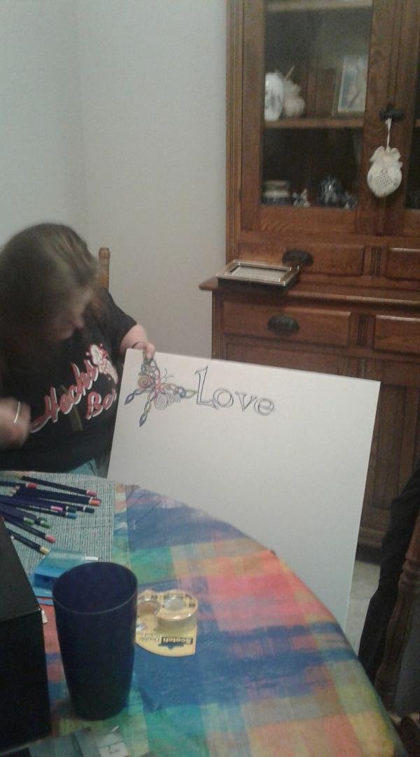 Jane adding color to the photo board I lettered for Mom's service...