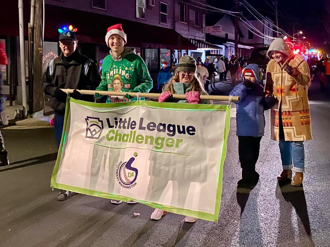 We had great time walking in the Washougal Lighted Christmas Parade tonight. Evan Miner and daughter Suzanne, both Little League Challenger division players, carried our Challenger banner with the East County Little League’