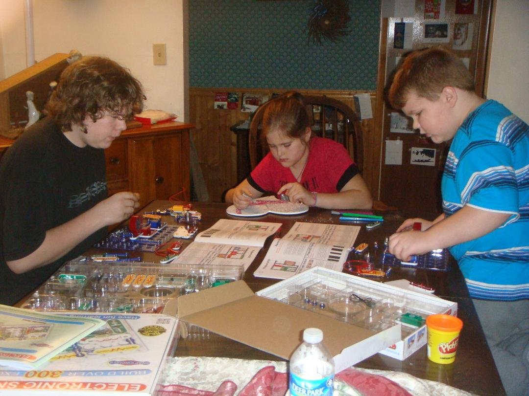 Grand kids being creative. Jaymee is doing some painting on a heart and the boys are working on their circuit sets.