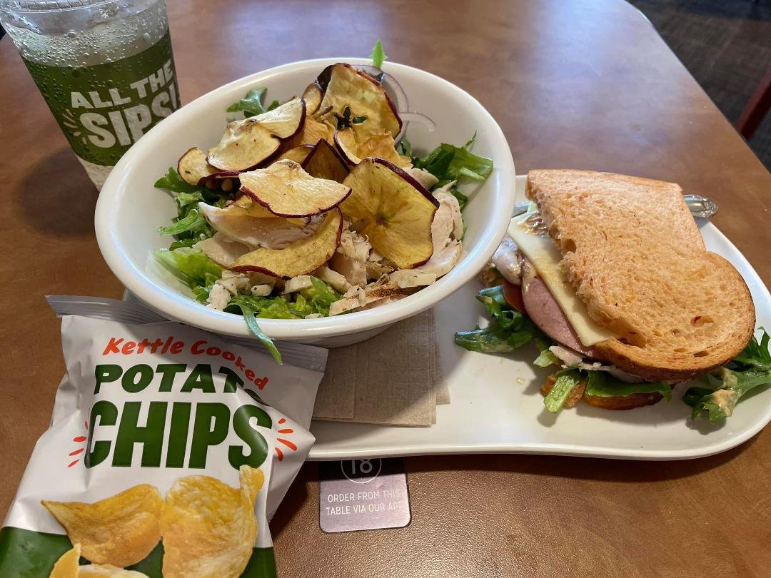 Having a half a bravo hero sandwich, half a chicken Fuji apple salad, chips & ginger ale drink!!
