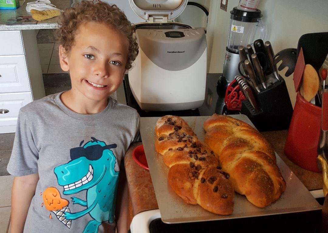 Several years ago Dean Haley, our grandson, learned to make Challah from his Papa (me). On this visit he wanted to do it again and for the last two Fridays he made Challah. You are right that is a bread machine and it sav