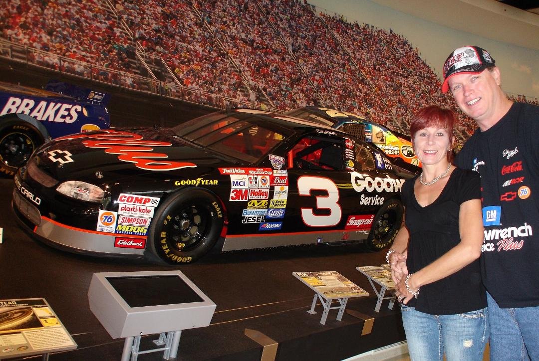 Tracey Diller Mitchell and Tom Mitchell in front of the best car in the place!