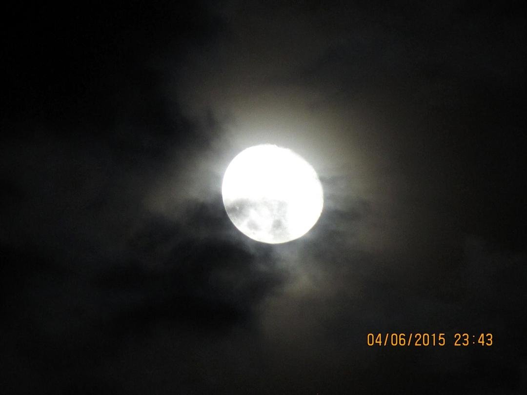 Tonight's moon sneaking out from behind the clouds for a moment