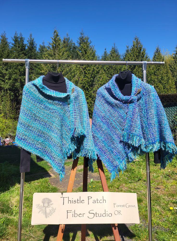 Ta-daa!
Two shawls done and ready for the Gathering of the Guilds sale, April 25, 26, & 27, 2025 at the Oregon Convention Center in Portland, Oregon. Free admission!
Stop by and see me at Thistle Patch Fiber Studio in the P