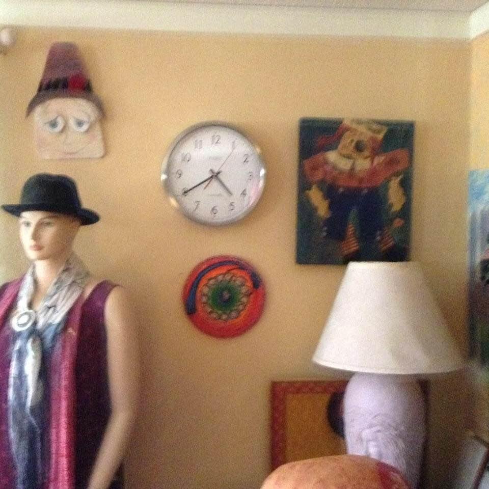 Excuse this picture, it's fuzzy. we wanted to send my step father a picture of our clock. SO, sent this. top left, fun face I made out of wood. Below that, a mannikin, under the clock a picture I drew years ago about th