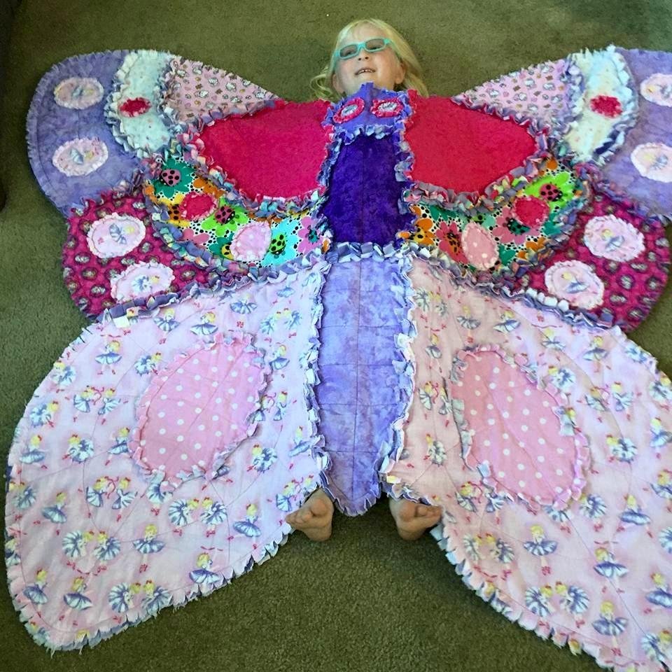 Abby, the butterfly, tries out her new blanket.