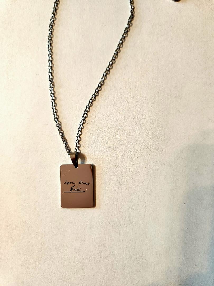 Just got this. Had it made using Hank's signature from a letter he sent me while I was a freshman at St. Mary and he was at K-State. It is stainless steel but it reflected my phone so you can't see the shine. I think it tur
