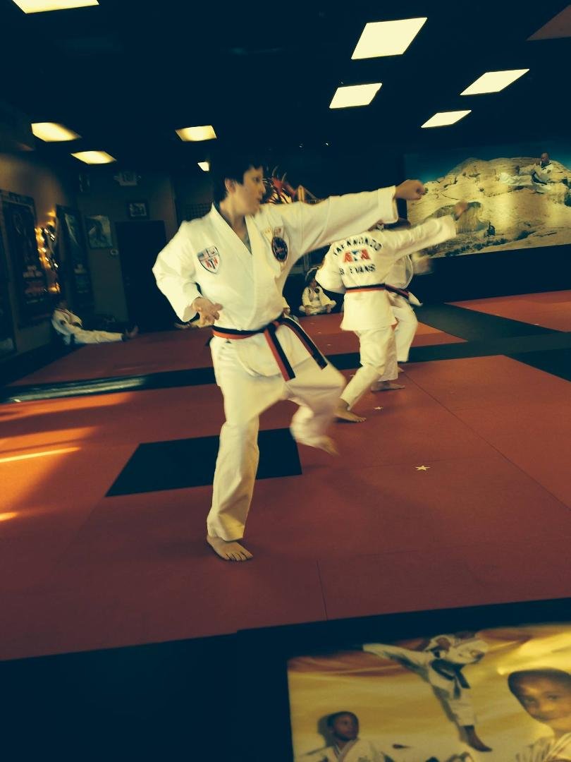 Justin getting his kicks out of Taekwando Black Belt testing.