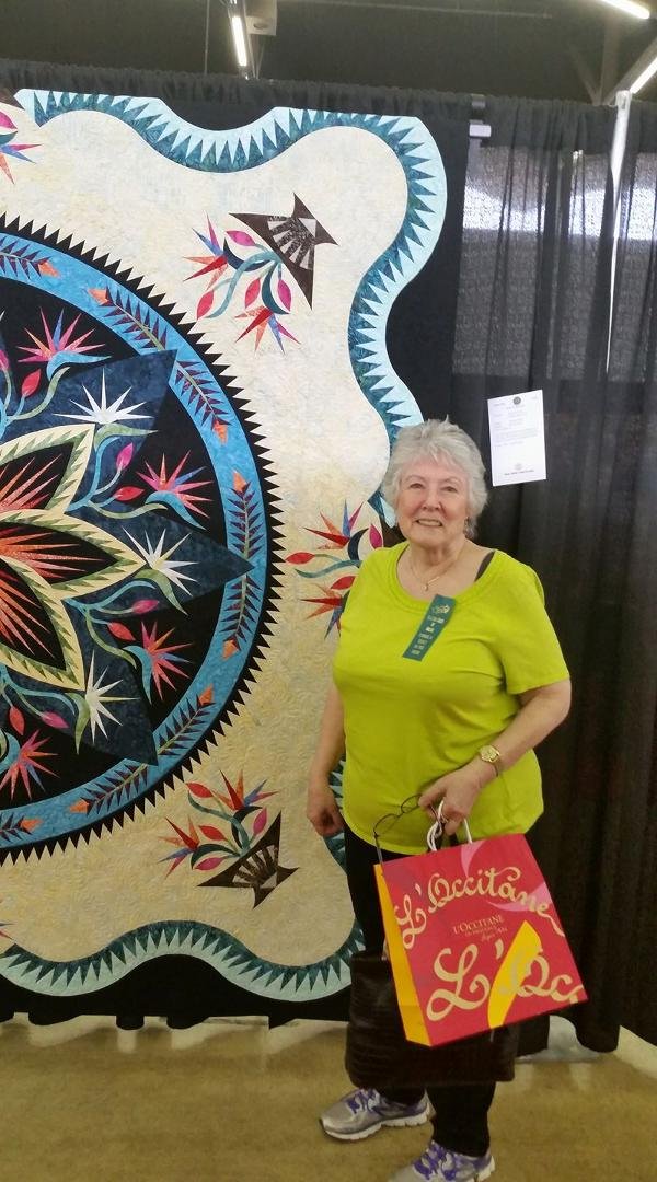 Rennae with her awesome quilt at the Dallas Quilt Show.