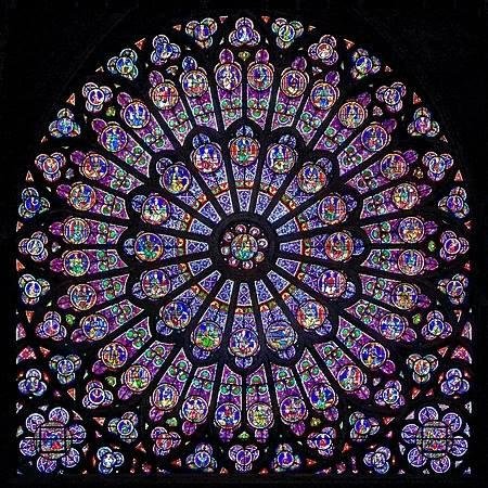 THIS IS THE ROSE STAINED GLASS WINDOW AT THE NOTRE DAME CATHEDRAL IN FRANCE.