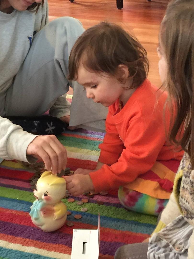 Emma filling her piggie bank......passed down from her grammy.