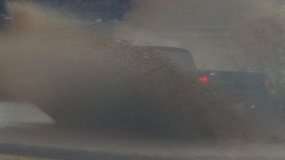 Idiots driving through water on roads,along with logs and full size trees