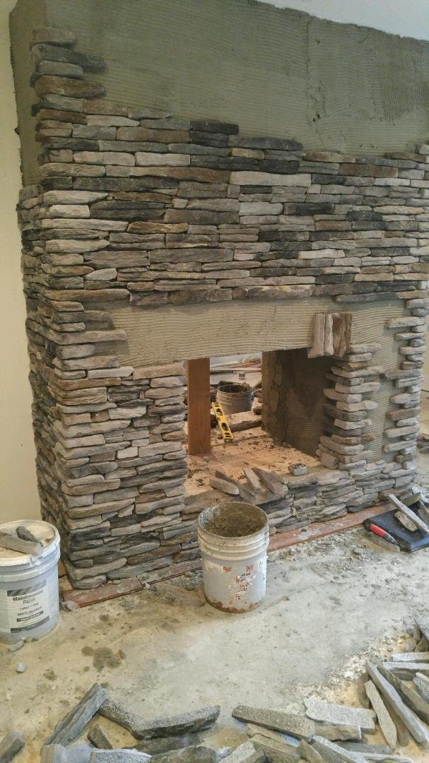 This is the bedroom side of the fireplace, the tile previously on the other side has been removed and will be replaced with this stacked stone. What a difference.