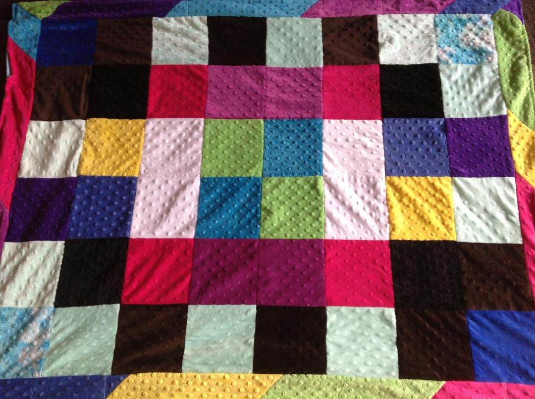 This is the quilt I just finished for Alex using her outgrown Triple Flip Minky Dimples sweaters - try saying that 3 times fast!  She designed the layout of the blocks herself