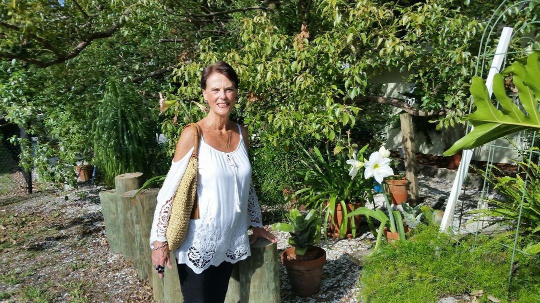 My beautiful wife looking at our lilies.