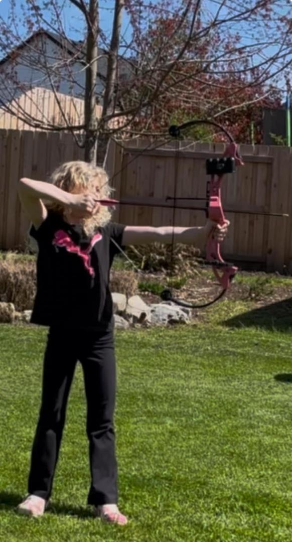 Young Artemis with her bow. Huntress Maddie in Pink, Black & Gold.