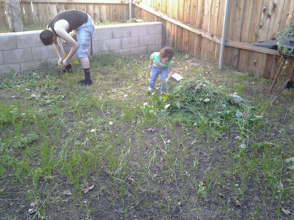 Zoe doing yard work with her brother Ernie