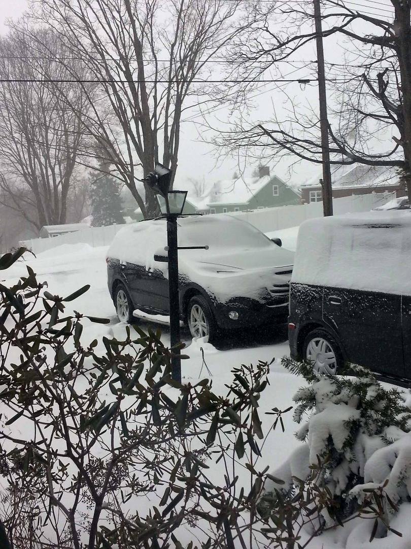 The wind has taken the top off the lamp post. Blowing and drifting makes it hard to tell how much snow has fallen. We've had micro-bursts where the white out conditions made it impossible to see the cars in the driveway.