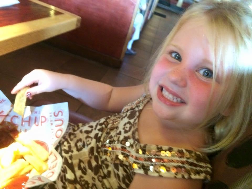 This girl sure likes her fries!