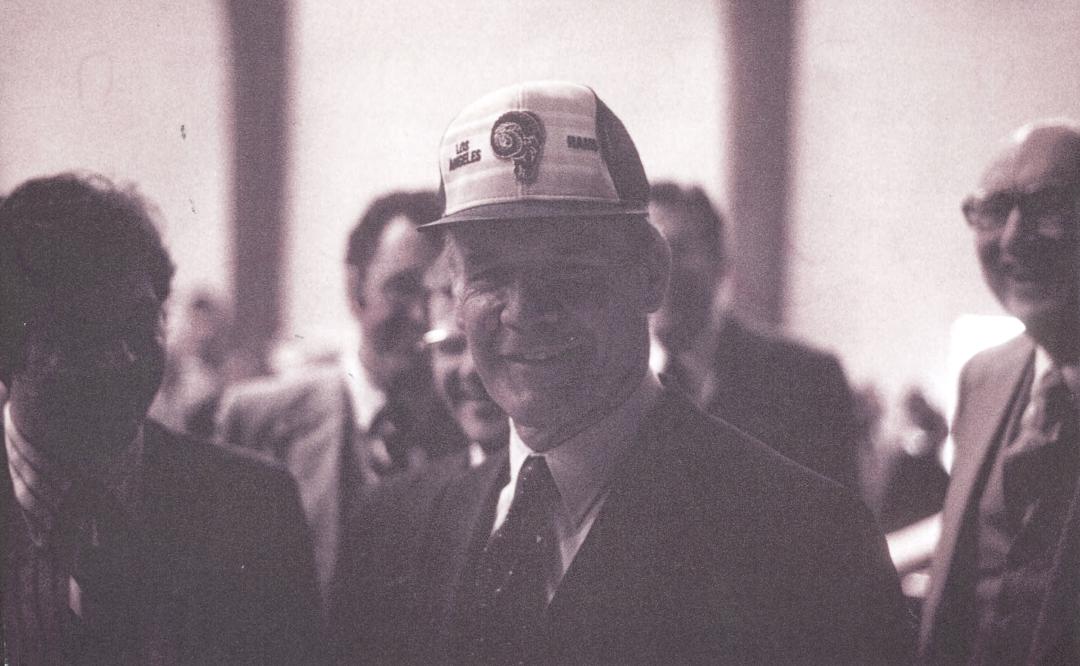Coach Tom Landry in Dallas Seminary's chapel, March 1981—44 years ago this month. Immediately after Landry spoke in chapel, I 'crowned' him with my LA Rams cap. A student took the picture. Landry slugged me when I put on th
